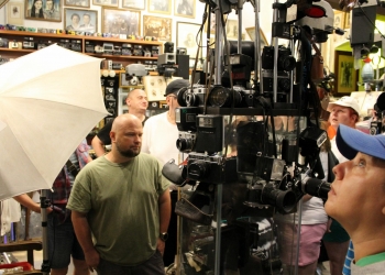 Zwiedzający ogladają zabytkowy sprzęt fotograficzny.