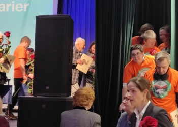 Członkowie Klubu Górskiego schodzą ze sceny. Wyróżniają się pomarańczowym kolorem koszulek.